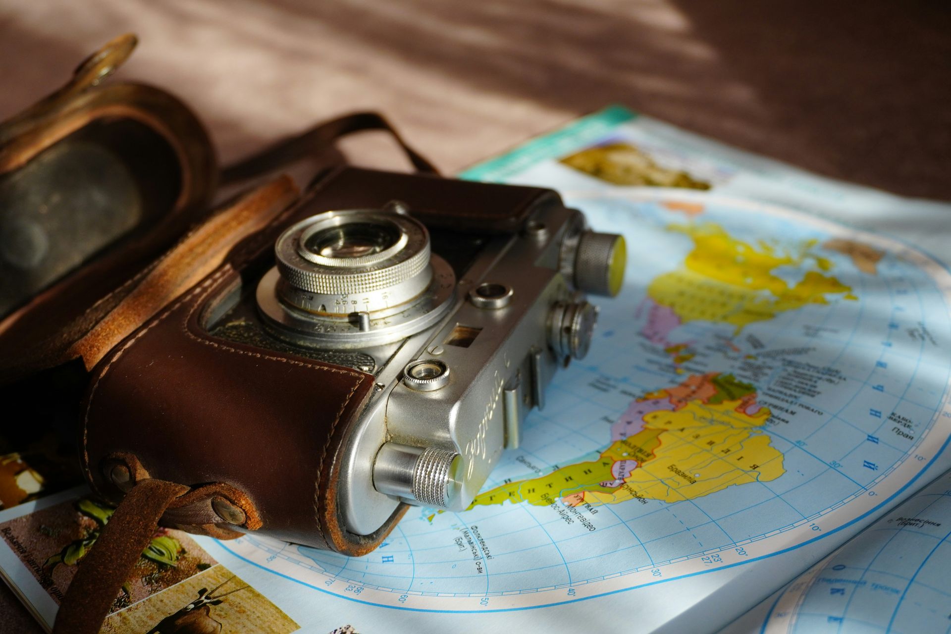 Vintage camera rests on a world map